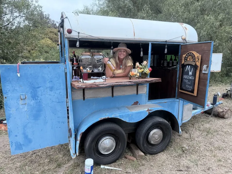 The vintage blue horse-trailer bar set up on the ranch